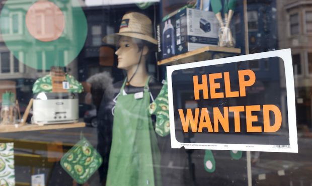 FILE: A help wanted sign is posted in the window of a hardware store on Sept. 16, 2021, in San Fran...