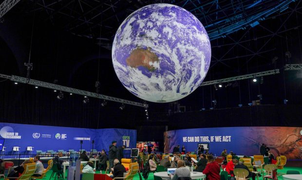 A giant globe hangs from the ceiling as delegates attend on day one of the COP 26 United Nations Cl...