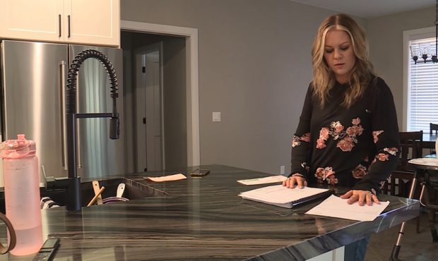 Jennifer Curtis goes through her payments to her contractor. (KSL TV)...