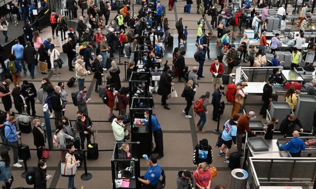 Travelers make their way through TSA security at Denver International Airport the day before Thanks...