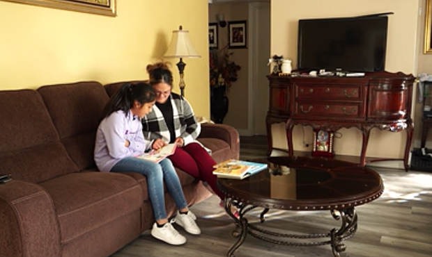 Sylvia Espinoza reads with her daughter Edith. (KSL TV)...