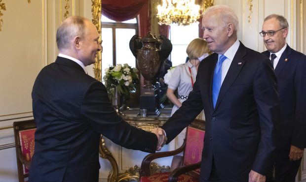 FILE: U.S. President Joe Biden (2L) and Russian President Vladimir Putin shake hands as Swiss Presi...