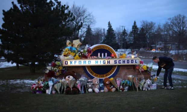 People visit a makeshift memorial outside of Oxford High School on December 01, 2021 in Oxford, Mic...