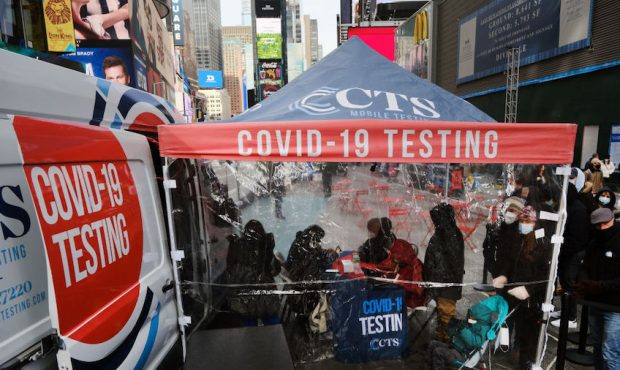 People wait in line to get tested for COVID-19 at a testing facility in Times Square on December 09...