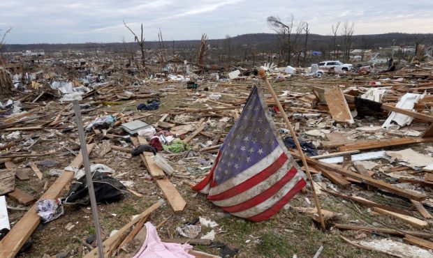 DAWSON SPRINGS, KENTUCKY - DECEMBER 15: A flag lays sits among debris from destroyed homes followin...