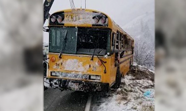 A school bus with one student on board slid off the road after hitting slushy conditions on state R...