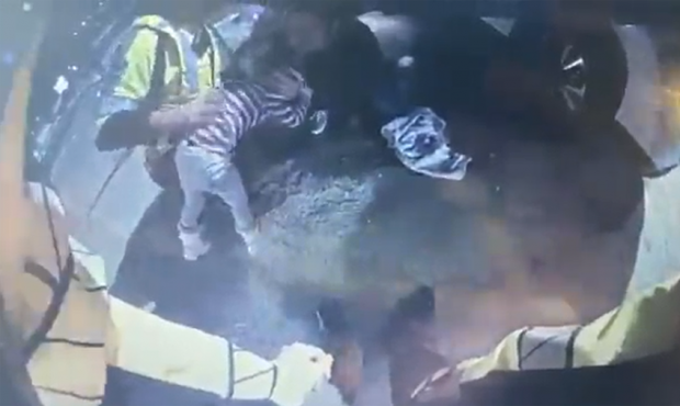 This image from body camera video shows a UDOT working save a choking child. (Used by permission, U...