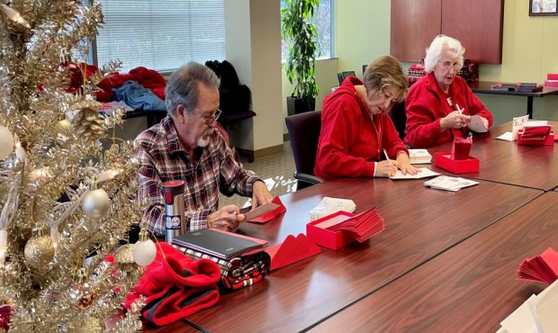 Volunteers with AARP write 250 cards to go with Giving Tree gifts for homebound seniors. (KSL TV) ...