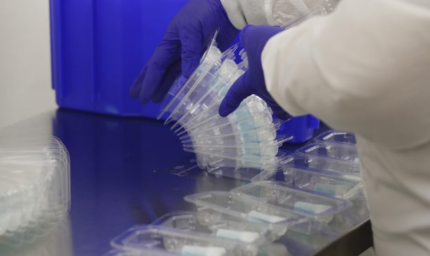 FILE: An employee at Spectrum Solutions assembles COVID-19 saliva test kits on September 21, 2020 i...