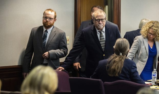 FILE: Greg McMichael, center, and his son, Travis McMichael, left, look at family members seated in...