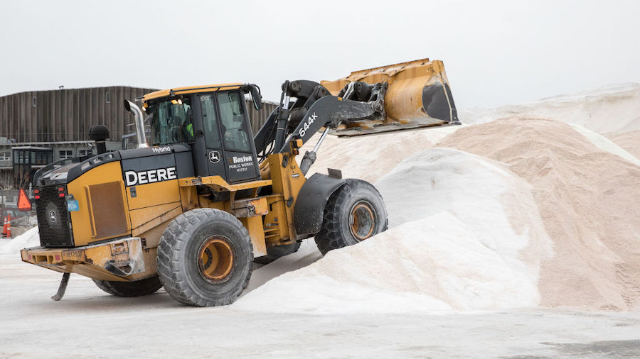 An excavator piles road salt in preparation for Winter Storm Kenan at the Boston Public Works Depar...