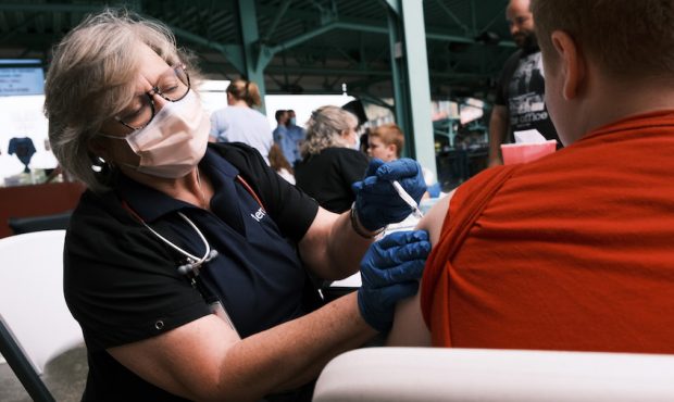 A nurse administers the Covid-19 vaccine to a teen at a baseball game on August 05, 2021 in Springf...