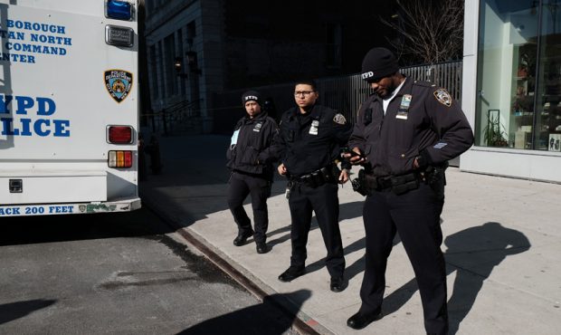 NEW YORK, NEW YORK - JANUARY 22: Police gather at the scene in Harlem where two New York City polic...