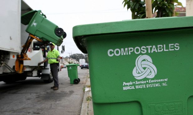 SAN FRANCISCO - JUNE 11:  Norcal Waste worker Manuel Vera dumps a bin with compostable materials in...