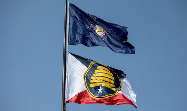 The Utah state flag, top, and the new commemorative state flag, below, fly atop the Capitol in Salt...