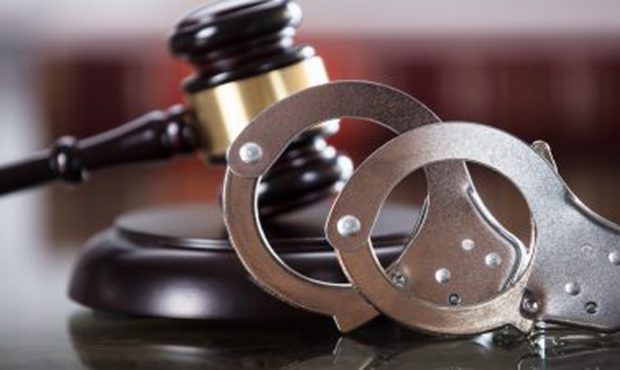 handcuffs in front of a gavel...