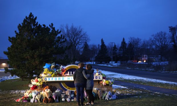 OXFORD, MICHIGAN - DECEMBER 01: People visit a makeshift memorial outside of Oxford High School on ...
