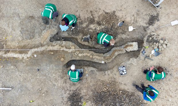Palaeontologists work at a site where remains of a Britain's largest ichthyosaur were found, at Rut...