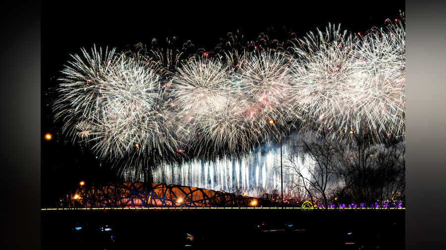 Fireworks explode over the Beijing National Stadium, also known as the Birds Nest, and the skyline ...