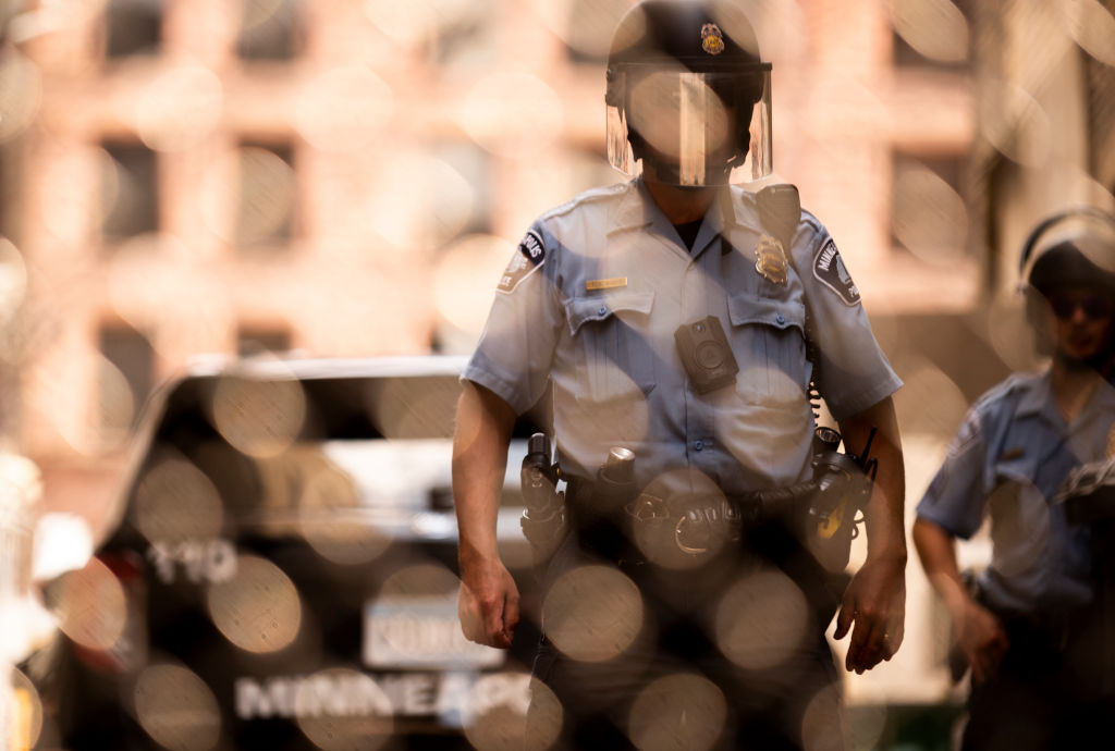 FILE: MINNEAPOLIS, MN - JUNE 13: Members of the Minneapolis Police Department seen through a chain ...