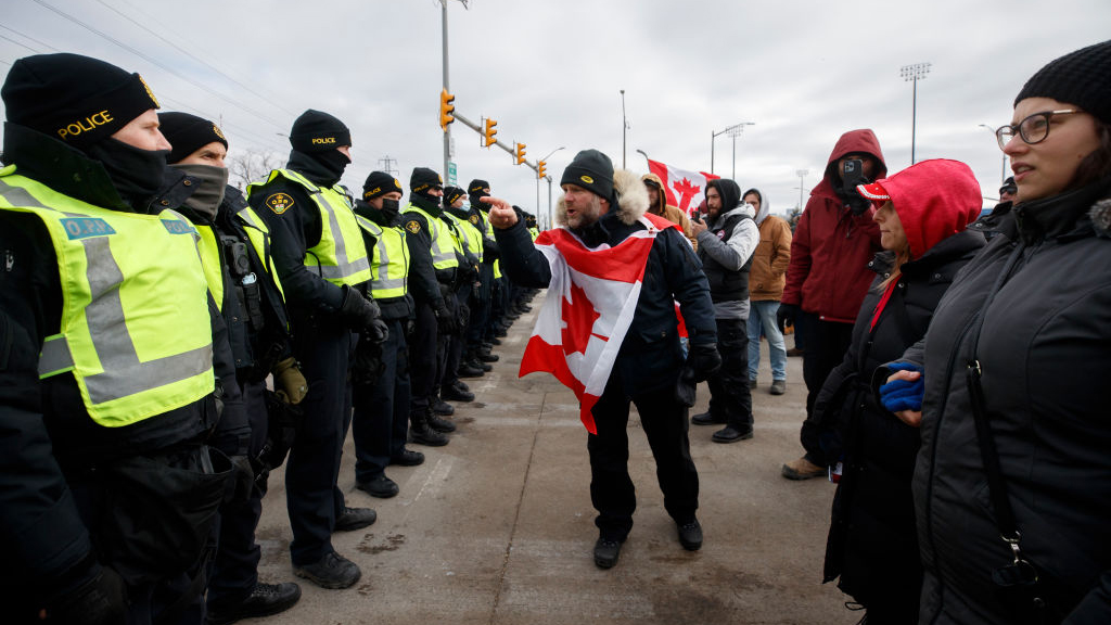 WINDSOR, ON - FEBRUARY 12: Protestors confront police as their try to clear protestors and their ve...