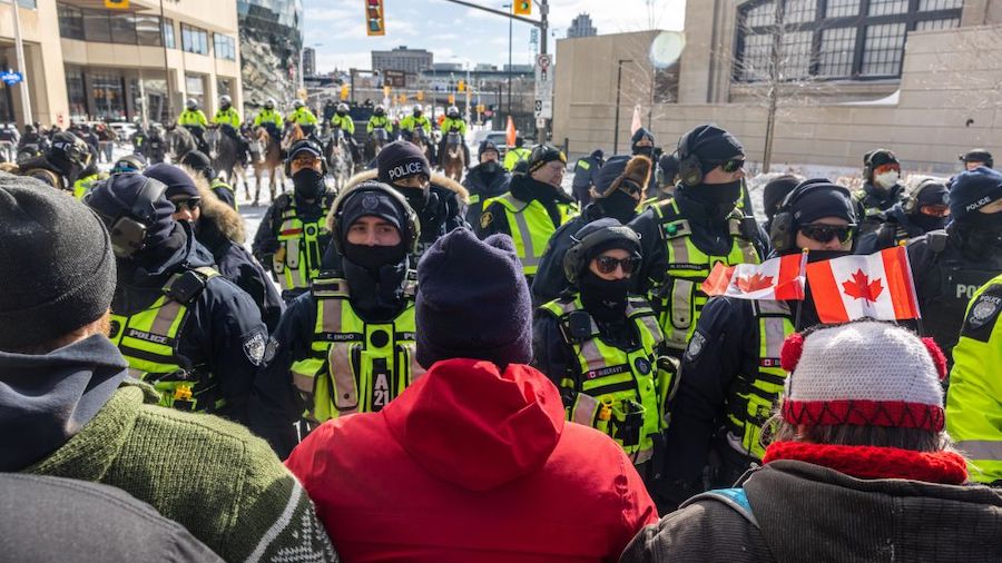 The police hold back protestors on February 18, 2022 in Ottawa, Ontario, Canada. Demonstrators gath...