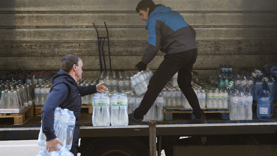 Delivery men deliver water to a grocery store on Feb. 23, 2022, in Kyiv, Ukraine. On Monday, Russia...