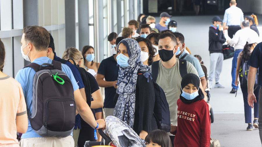 People line up at the Histopath pre-departure COVID testing clinic at Sydney International airport ...