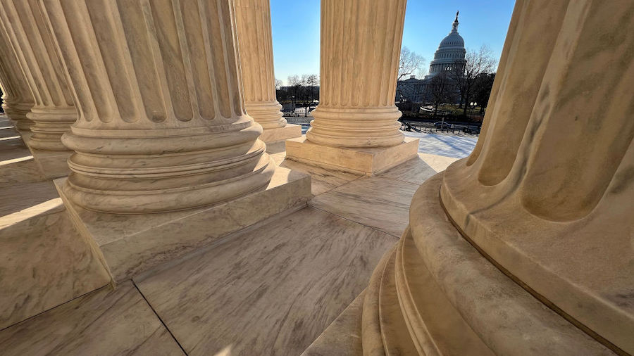 The U.S. Capitol Building stands across First Avenue NW from the U.S. Supreme Court building on the...