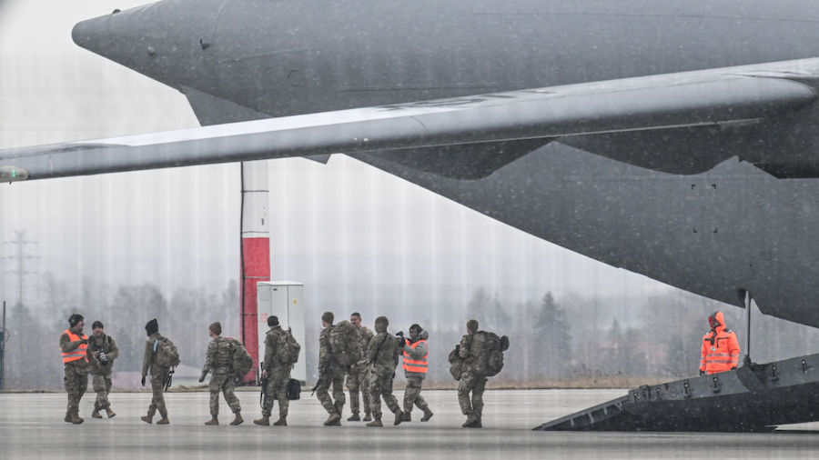 US Army Soldiers exit a U.S. Air Force Boeing C-17A Globemaster III transport aircraft at Jasionka ...