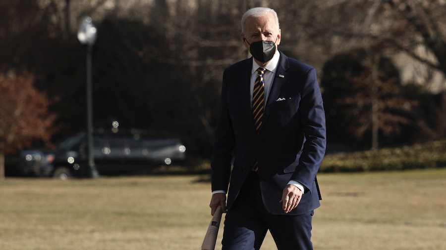 President Joe Biden walks across the South Lawn after returning on Marine One to the White House on...