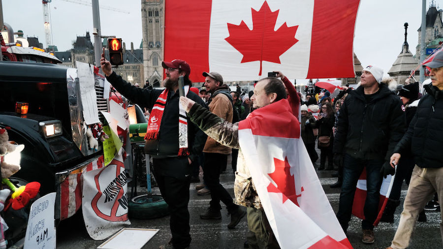 Truck drivers and their supporters gather to block the streets of downtown Ottawa as part of a conv...