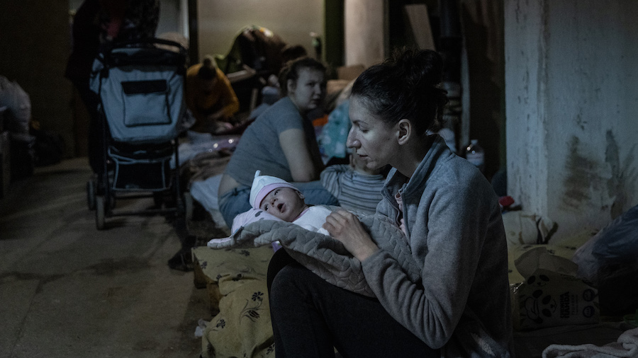 A mother tends to her baby that is under medical treatment in the bomb shelter of the paediatric wa...