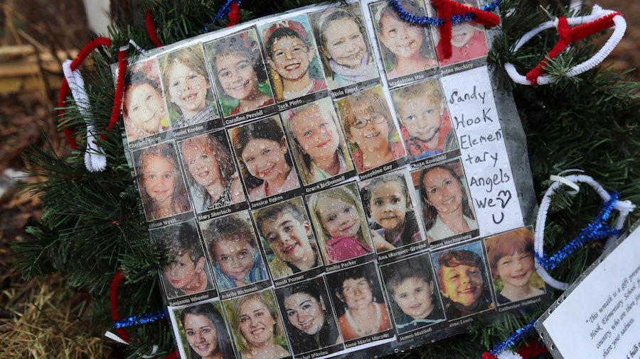 FILE: Photos of Sandy Hook Elementary School massacre victims sits at a small memorial near the sch...