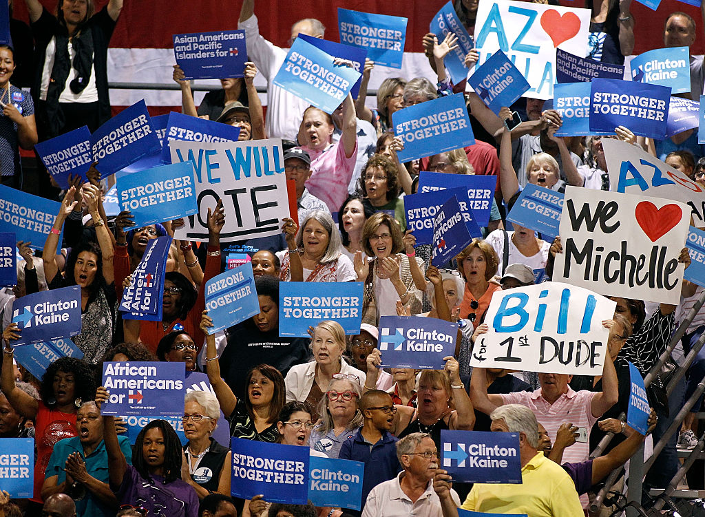 FILE: PHOENIX, AZ - OCTOBER 20:  Supporters for presidential nominee Hillary Clinton hold up signs ...