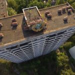 PRIPYAT, UKRAINE - AUGUST 19:  In this aerial view a Soviet-era hammer and sickle stands on top of an abandoned apartment building in the ghost town of Pripyat not far from the Chernobyl nuclear power plant on August 19, 2017 in Pripyat, Ukraine. On April 26, 1986 reactor number four exploded after a safety test went wrong, spreading radiation over thousands of square kilometers in different directions. The nearby town of Pripyat, which had a population of approxiamtely 40,000 and housed the plant workers and their families, was evacuated and has been abandoned ever since.  (Photo by Sean Gallup/Getty Images)