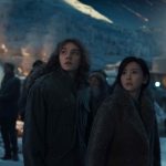 Charlie Plummer (’Sonny Harper,’ left) and Kelly Yu (’Michelle,’ right) peering to the moon in the sci-fi epic MOONFALL.