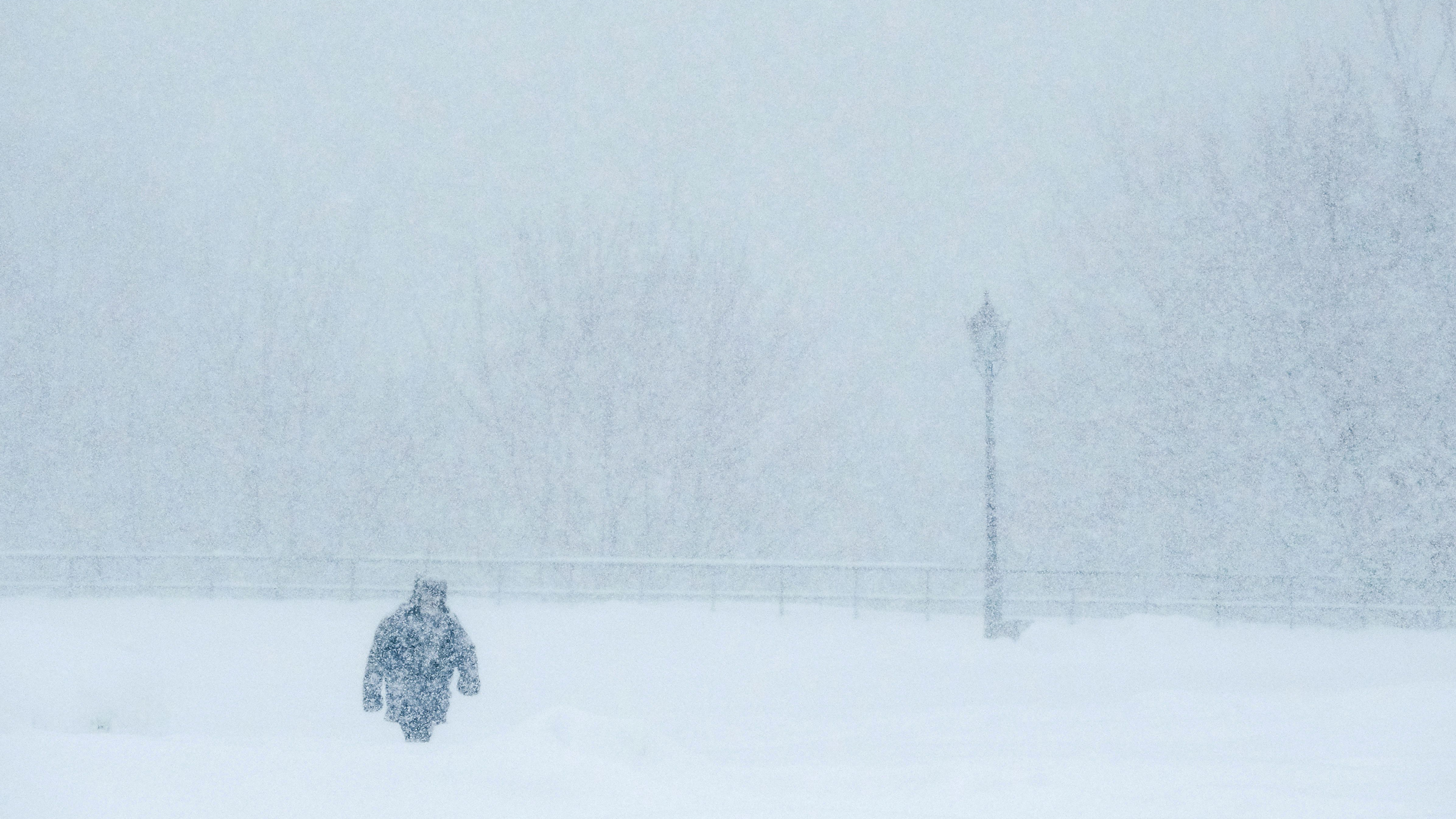 TOPSHOT - A man walks during a strong snowfall at the Kolomenskoye museum-reserve in Moscow on Febr...