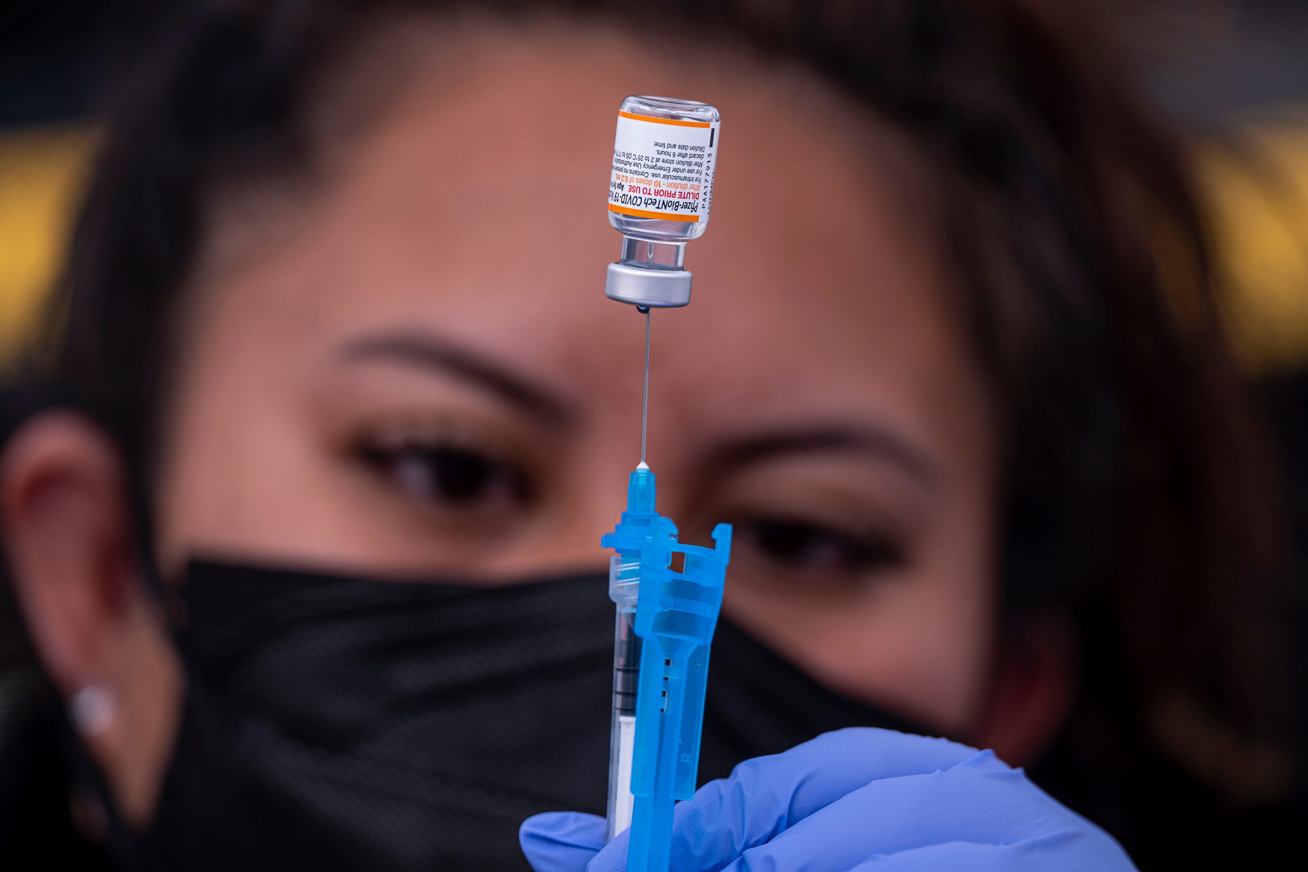 A healthcare worker prepares a dose of Pfizer-BioNTech Covid-19 vaccine at a vaccination site in Sa...