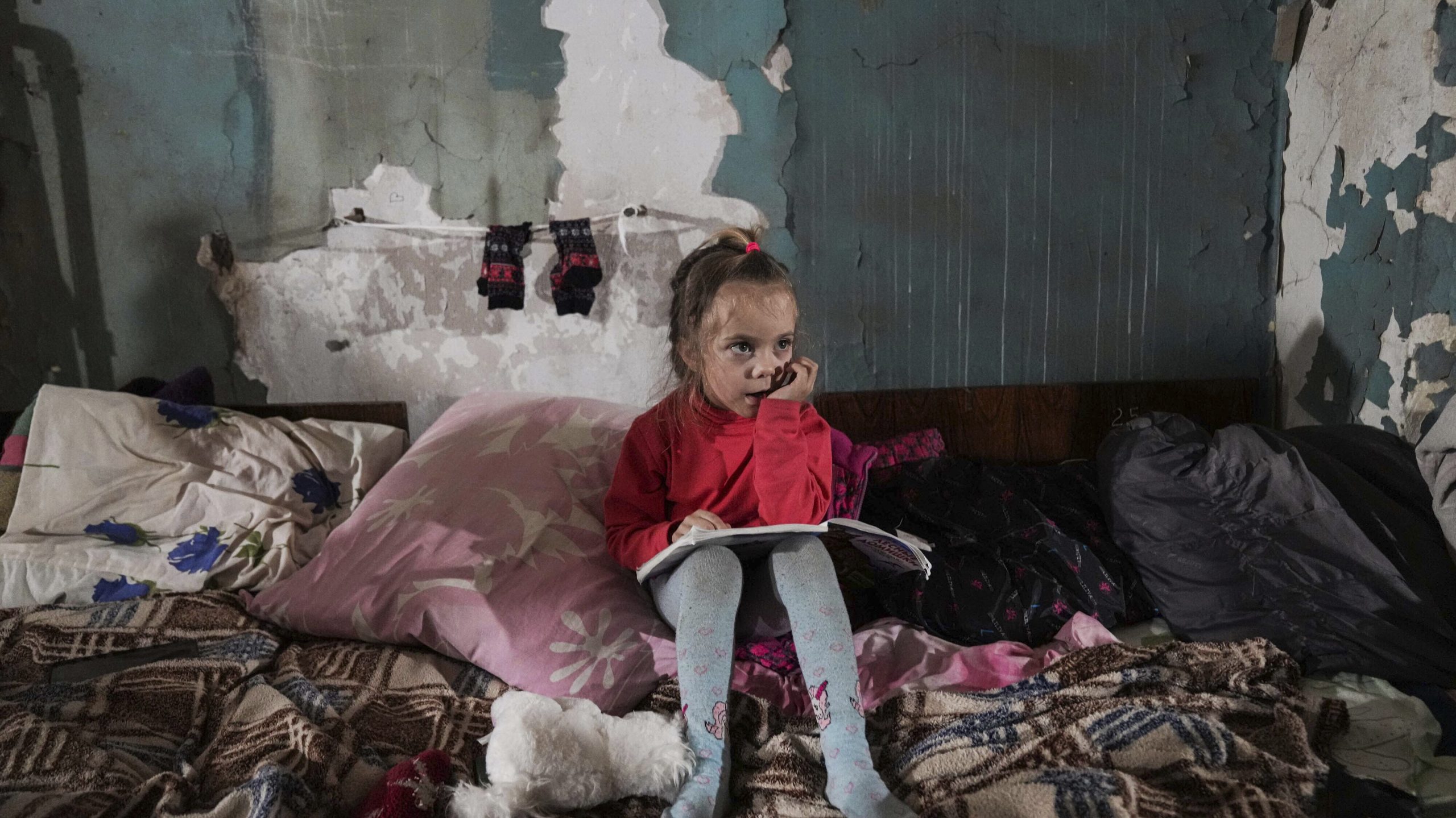 A girl sits in the improvised bomb shelter in Mariupol, Ukraine, Monday, March 7, 2022. (AP Photo/E...