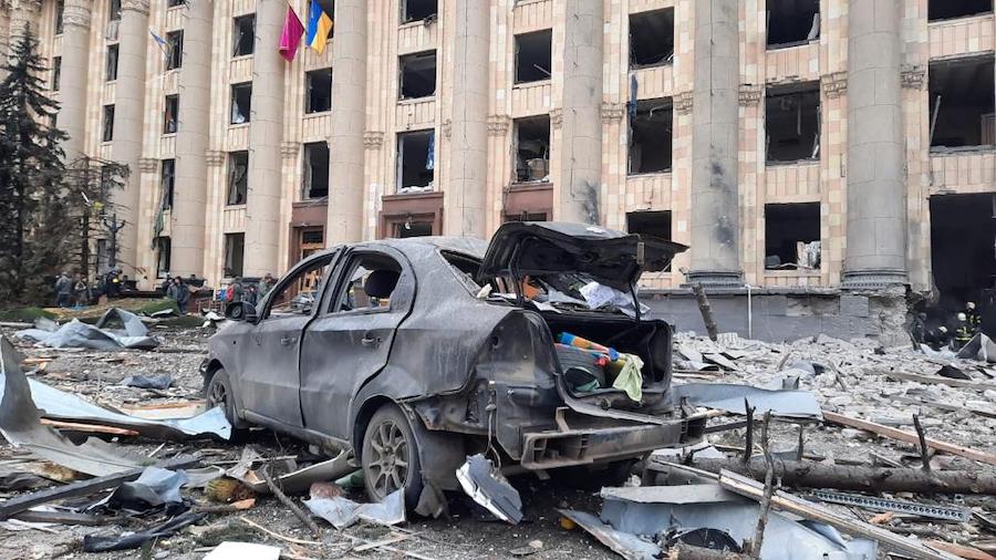 In this handout photo released by Ukrainian Emergency Service, a burnt car is seen in front of a da...