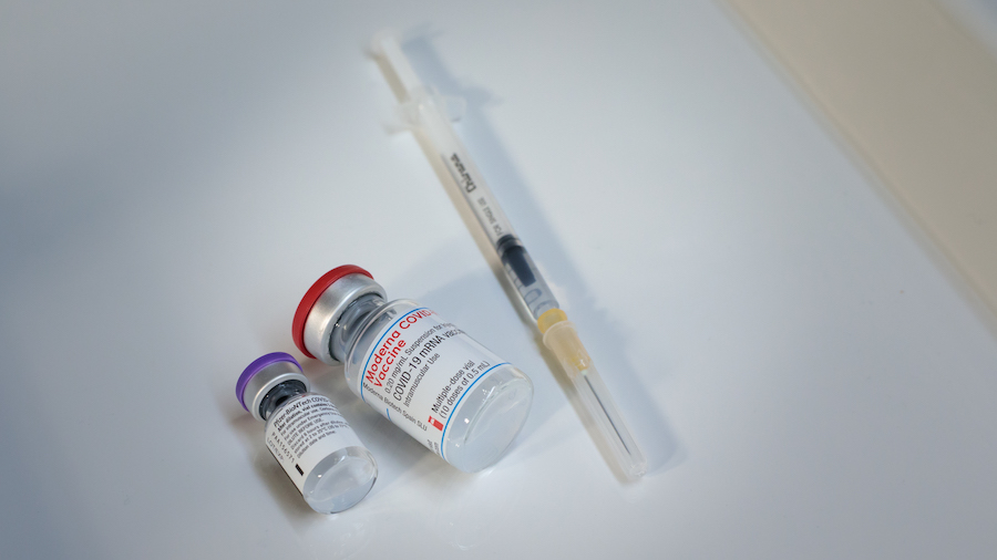 FILE: Pfizer-BioNTech COVID-19 (left) and Moderna COVID-19 (right) vaccines are seen at a vaccinati...