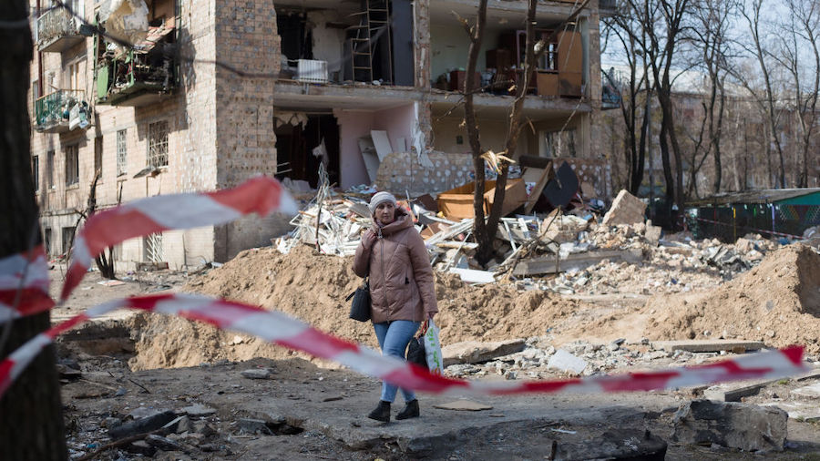 A woman walks through the residential area which was destroyed as a result of a rocket strike two w...