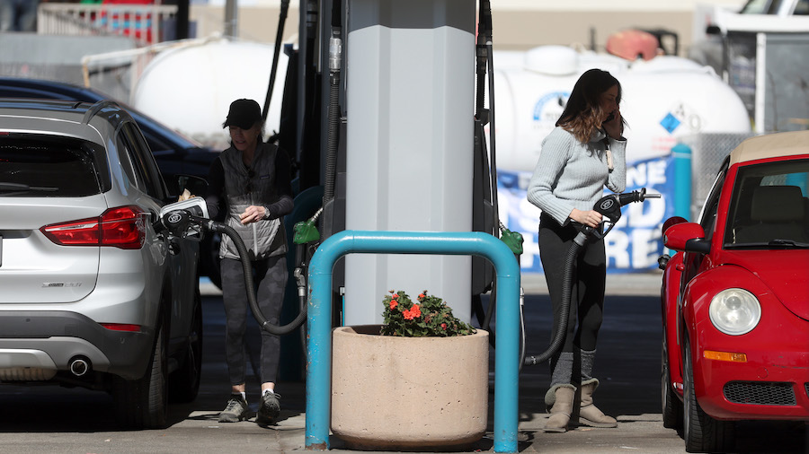 Customers pump gas into their cars at a Valero gas station on Feb. 23, 2022, in Mill Valley, Califo...