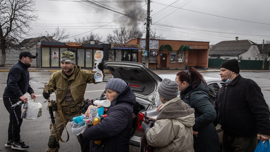 IRPIN, UKRAINE - MARCH 03: Residents crowd around to get food and other items handed out by members...