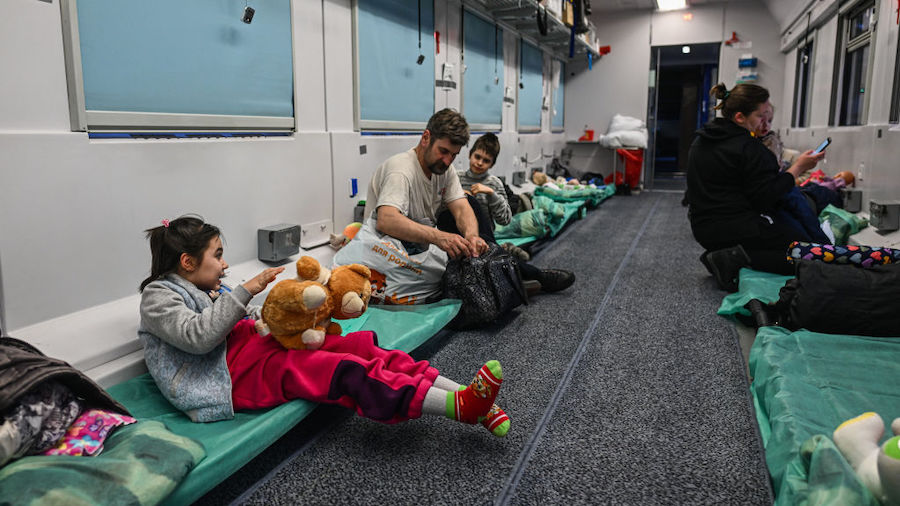 A girl plays with a teddy bear inside a train wagon transformed for medical transport on March 10, ...