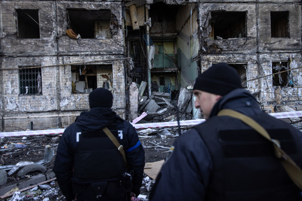 KYIV, UKRAINE - MARCH 14: Police stand in front of a residential apartment block that was hit by Ru...