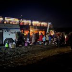 A bus loading up with refugees headed for Germany. The Utah Volunteers packed travel kits for them to use on the long 40 hour ride.