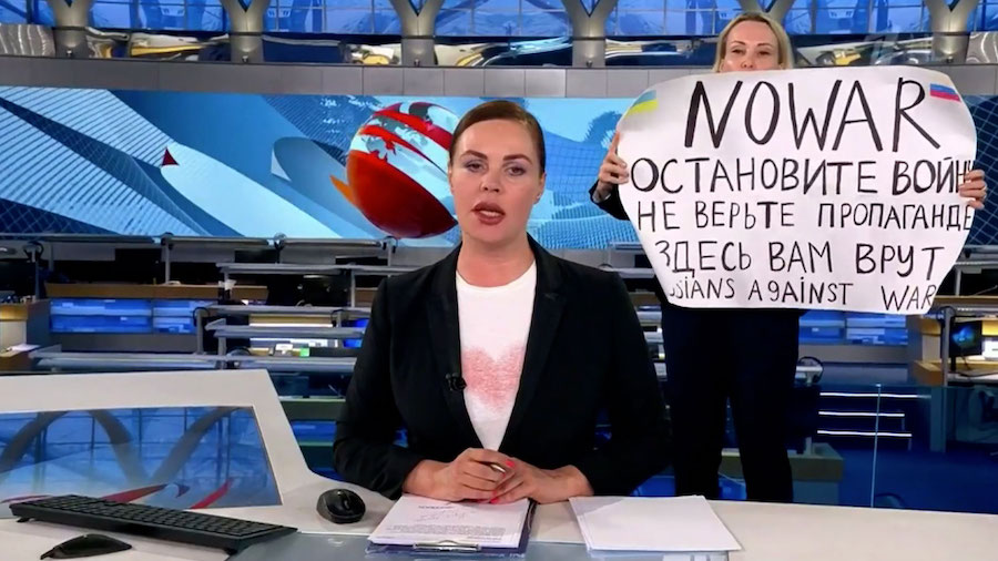 A woman holding a sign reading "NO WAR" interrupted a live news broadcast on Russian state televisi...