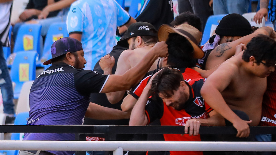 Fans clash in the stands during the match between Querétaro and Atlas. (Manuel Velasquez/Getty Ima...